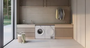 Sèche-linge blanc encastré à côté d'un lave-linge, dans une buanderie moderne avec linge suspendu - réparation sèche-linge Genève, Suisse Dépannage