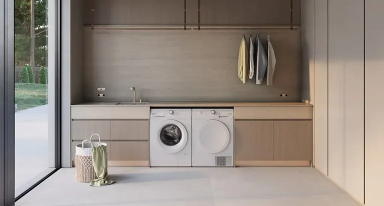 Sèche-linge blanc encastré à côté d'un lave-linge, dans une buanderie moderne avec linge suspendu - réparation sèche-linge Genève, Suisse Dépannage