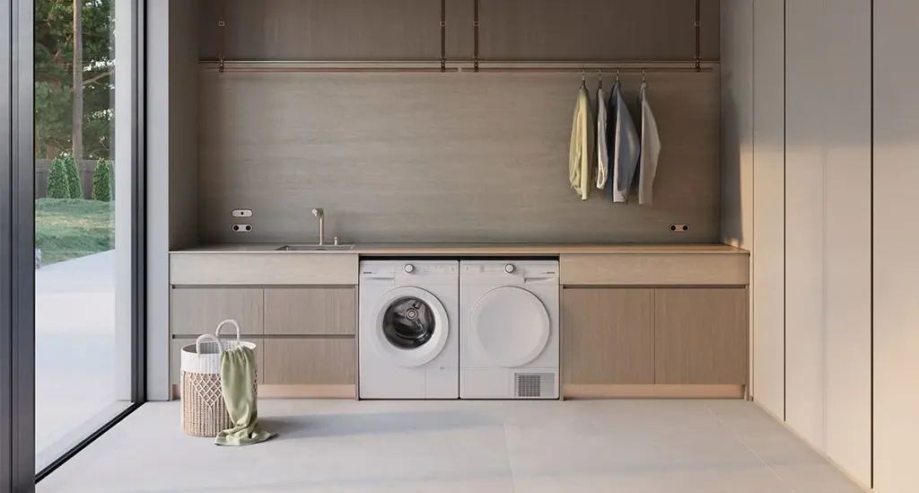 Sèche-linge blanc encastré à côté d'un lave-linge, dans une buanderie moderne avec linge suspendu - réparation sèche-linge Genève, Suisse Dépannage